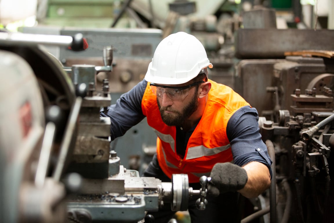 Male Manufacturing Engineer Operating Machinery at the Factory
